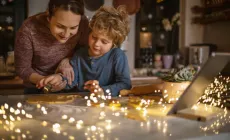 adult and child working on craft project, sparkling lights