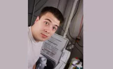 teenage boy at washing machine lookng shocked 