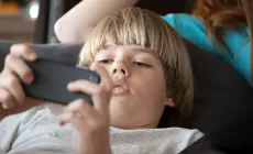 Boy playing on smart phone