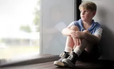 boy staring out window