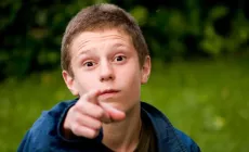 boy points at camera accusingly